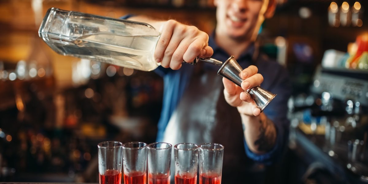 male-barman-in-apron-prepares-alcoholic-coctail.jpg
